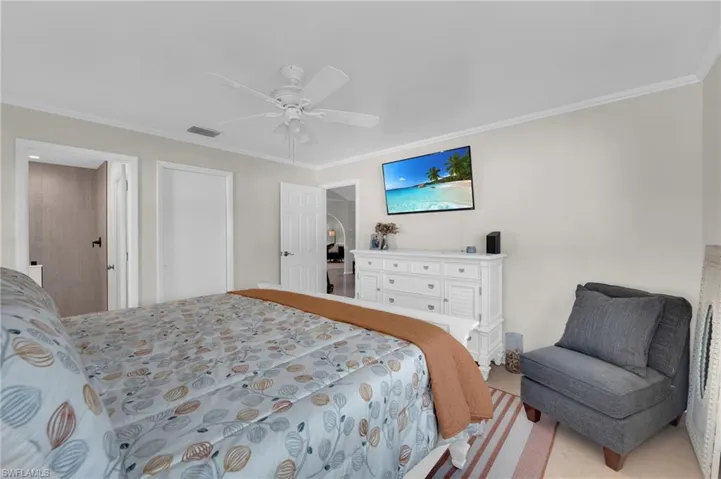 Bedroom with crown molding and ceiling fan