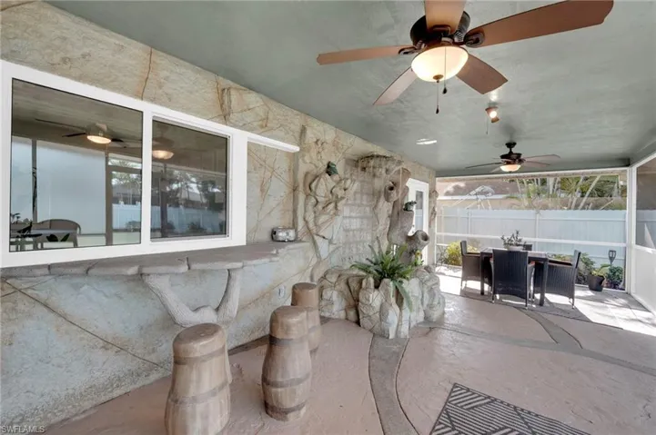 View of patio featuring outdoor dining area and ceiling fan