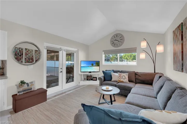 Living room with french doors and vaulted ceiling
