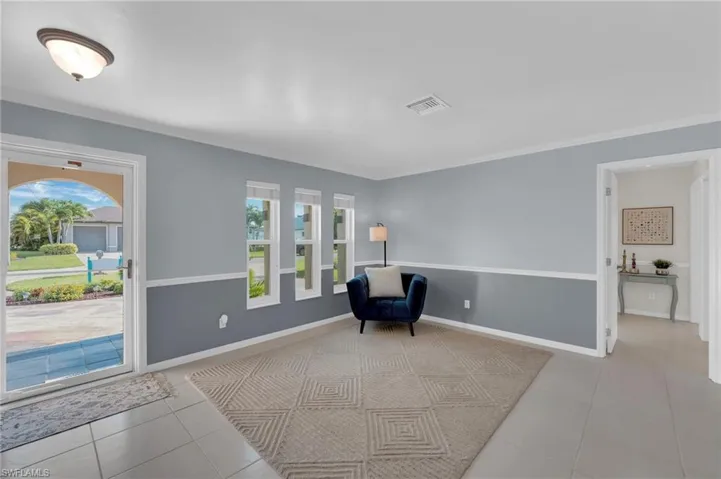 Unfurnished room with plenty of natural light, tile patterned floors, and crown molding