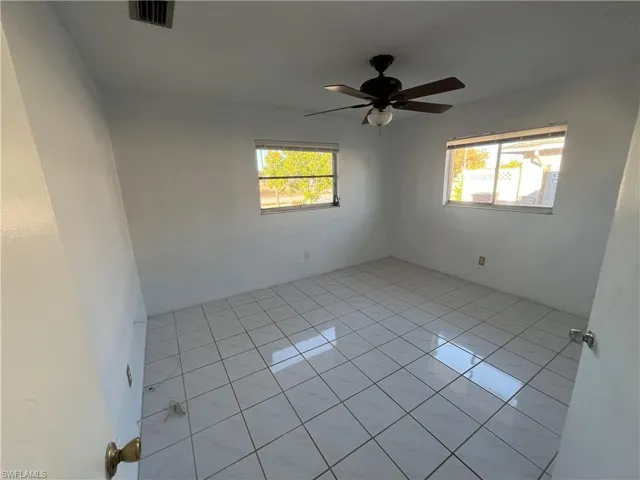 Spare room featuring light tile patterned floors and ceiling fan