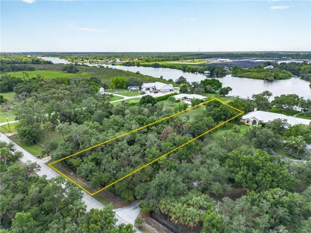 Birds eye view of property with a water view