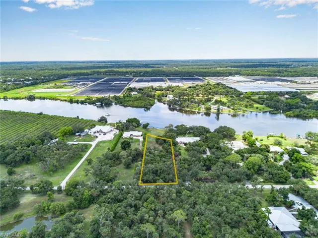 Birds eye view of property with a water view