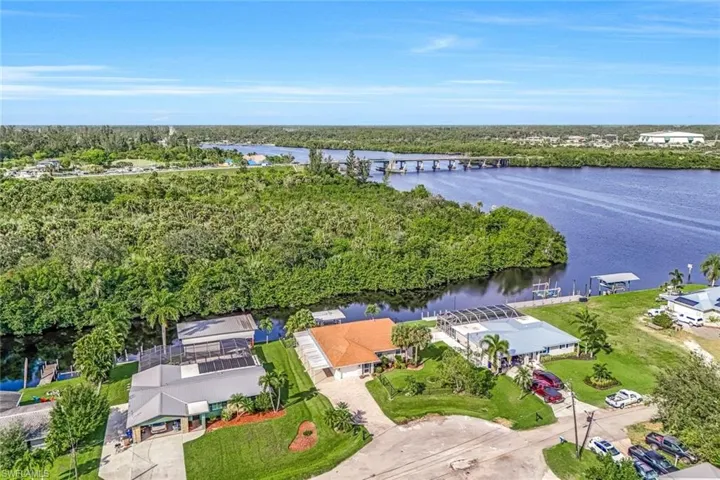Birds eye view of property with a water view