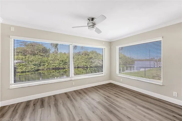 room featuring crown molding, ceiling fan, and hardwood / wood-style flooring