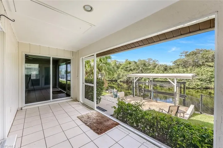 Unfurnished sunroom featuring a water view