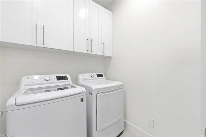 Laundry area with cabinet space and washer and dryer