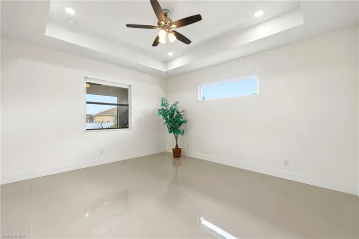 Spare room with ceiling fan, light tile patterned floors, and recessed lighting