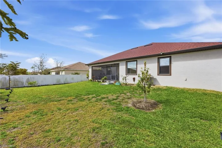 Back of property with a sunroom and stucco siding