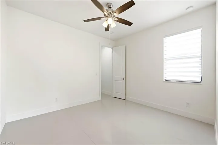 Spare room with a ceiling fan and light tile patterned flooring