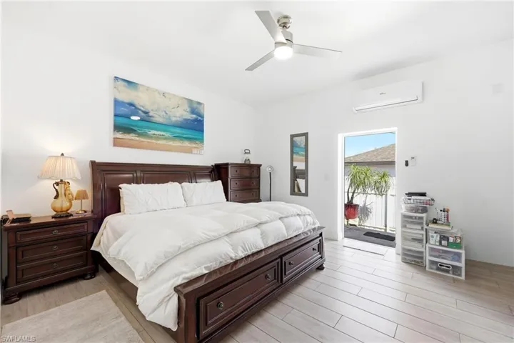 Bedroom featuring light wood-style flooring, access to outside, and ceiling fan