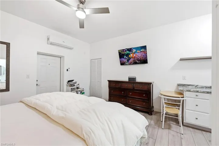 Bedroom featuring a closet, wood tiled floors, and a ceiling fan