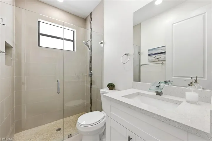 Bathroom with vanity and a stall shower