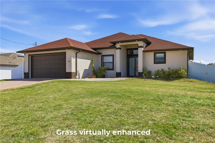 Prairie-style home with an attached garage, driveway, and stucco siding