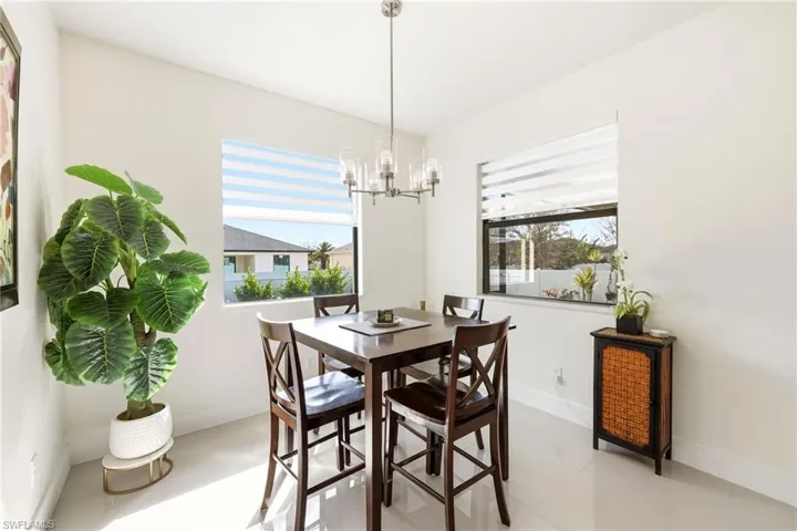 Dining room with baseboards and hanging lights