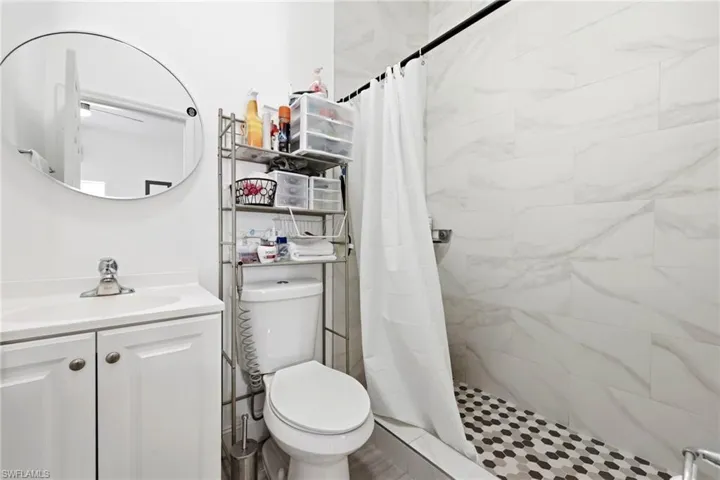 Full bathroom with vanity and a shower stall