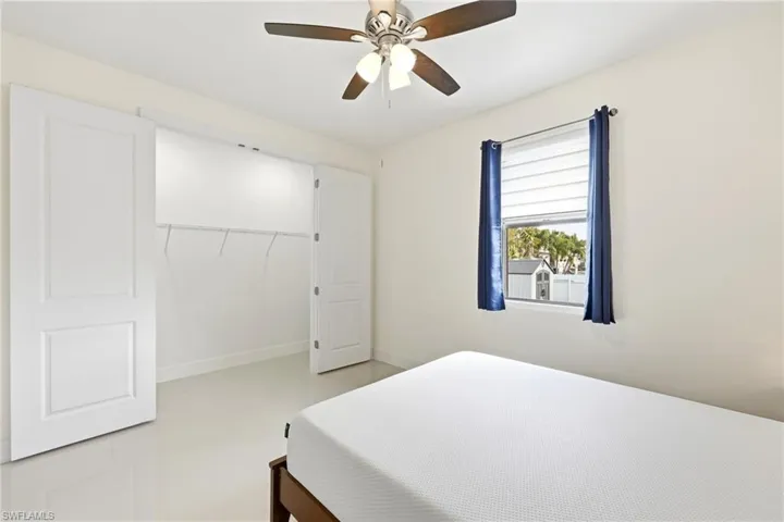 Bedroom with a ceiling fan and a closet