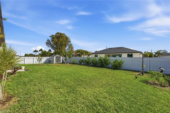 Fenced backyard with a shed