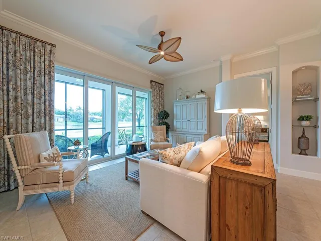 Tiled living room featuring ornamental molding and ceiling fan
