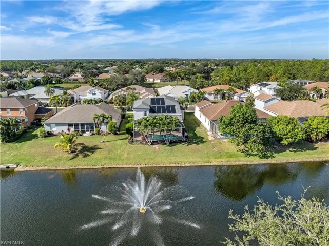 Aerial view of residential area featuring a large body of water