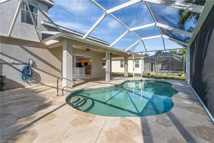 Swimming pool with a sunroom, a patio, and a lanai