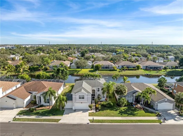 Aerial perspective of suburban area featuring a large body of water