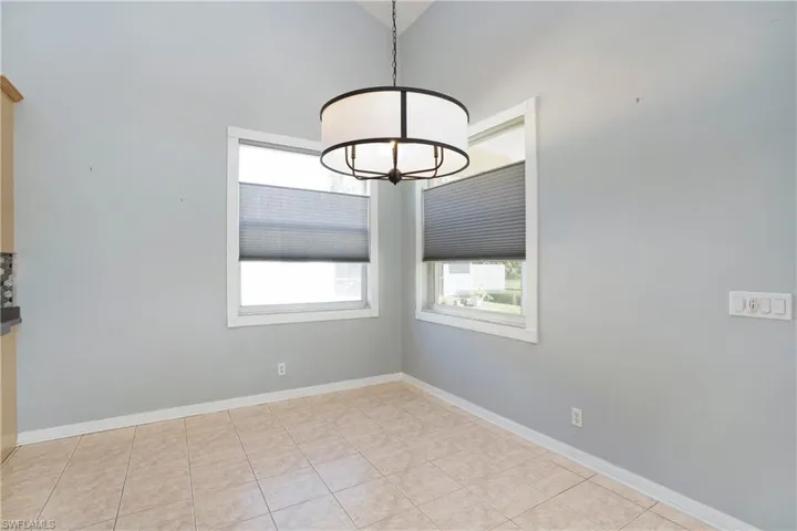 Unfurnished dining area featuring plenty of natural light and a chandelier