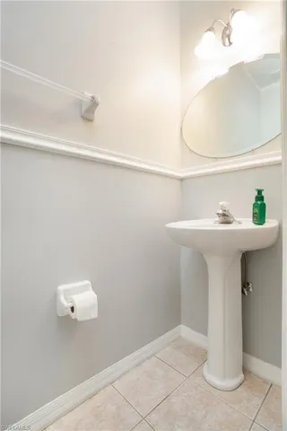 Bathroom with baseboards and light tile patterned floors