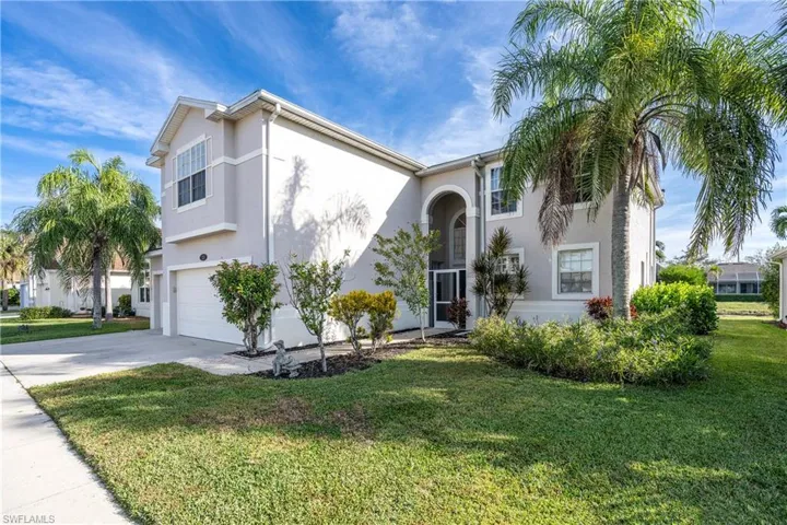View of front of house featuring stucco siding, a front lawn, and concrete driveway