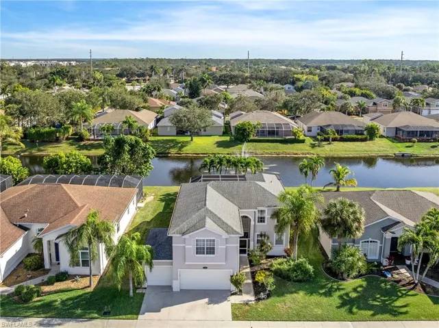 Aerial view of residential area featuring a nearby body of water