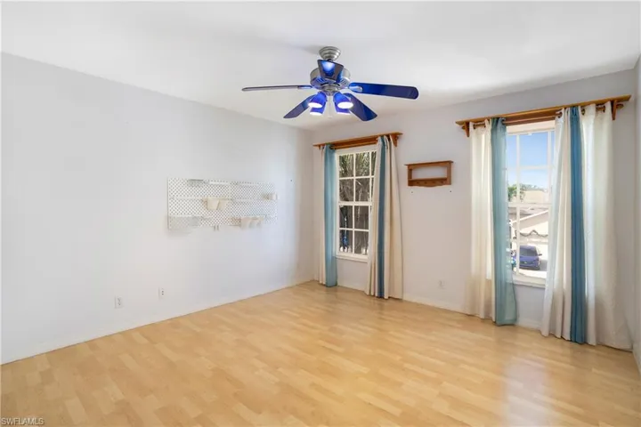 Spare room with light wood finished floors and ceiling fan