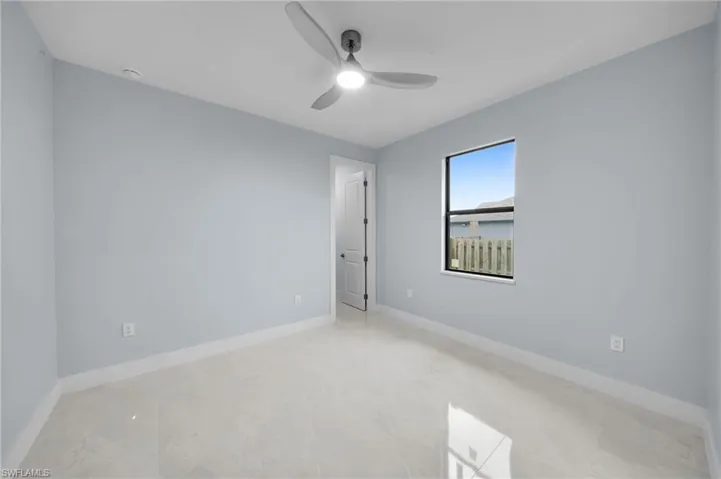 Empty room with baseboards and ceiling fan