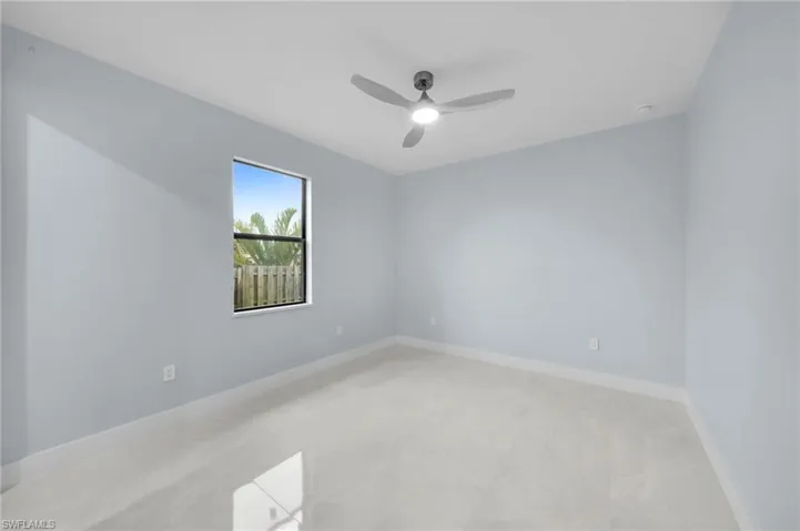 Spare room with baseboards and ceiling fan