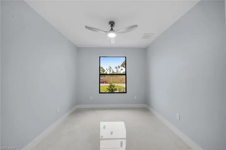 Unfurnished room with visible vents, baseboards, and ceiling fan