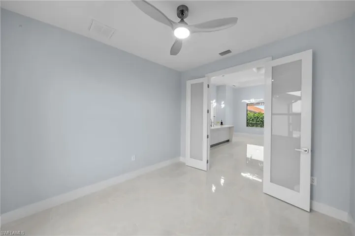 Unfurnished bedroom with french doors, baseboards, and visible vents