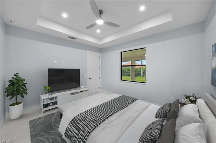 Bedroom with visible vents, baseboards, a tray ceiling, recessed lighting, and ceiling fan