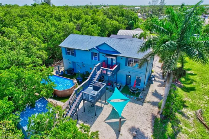 View of play area with stairs, a deck, an outdoor pool, and a patio area