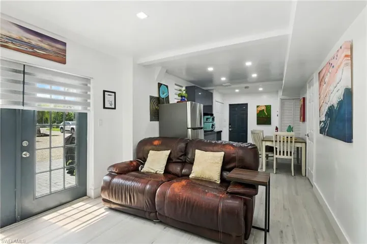 Living room featuring light wood-style flooring and recessed lighting