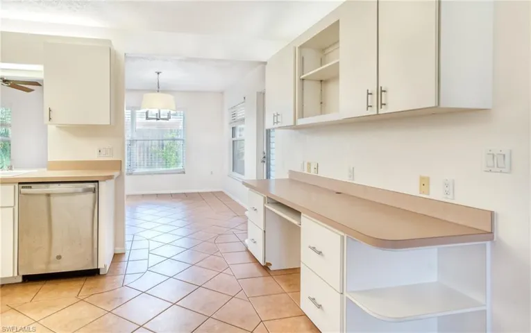 Kitchen with ceiling fan, hanging light fixtures, and dishwasher