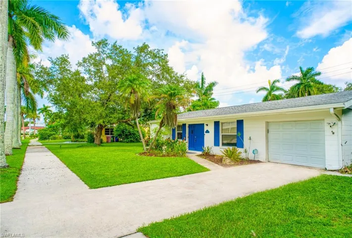 Ranch-style home with a front lawn and a garage