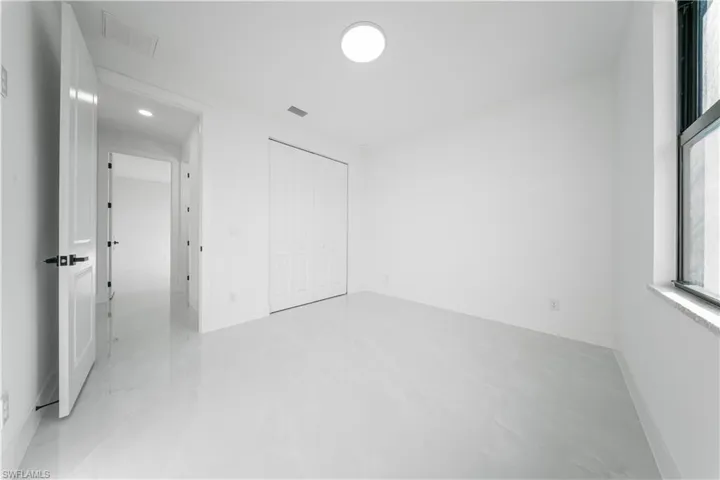 Unfurnished bedroom featuring a closet and baseboards