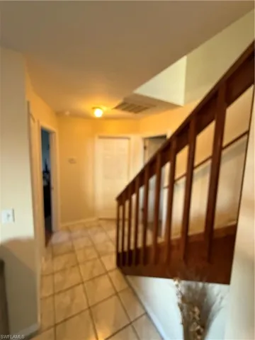 Stairs featuring tile patterned flooring