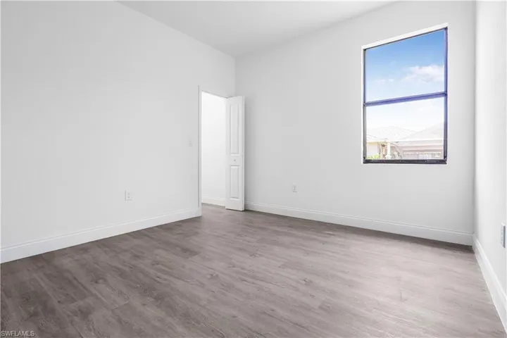 Empty room featuring wood finished floors and baseboards