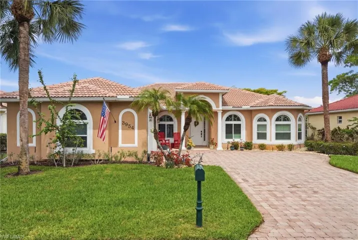 Single home , one story, stucco siding, a tile roof, front lawn and driveway.