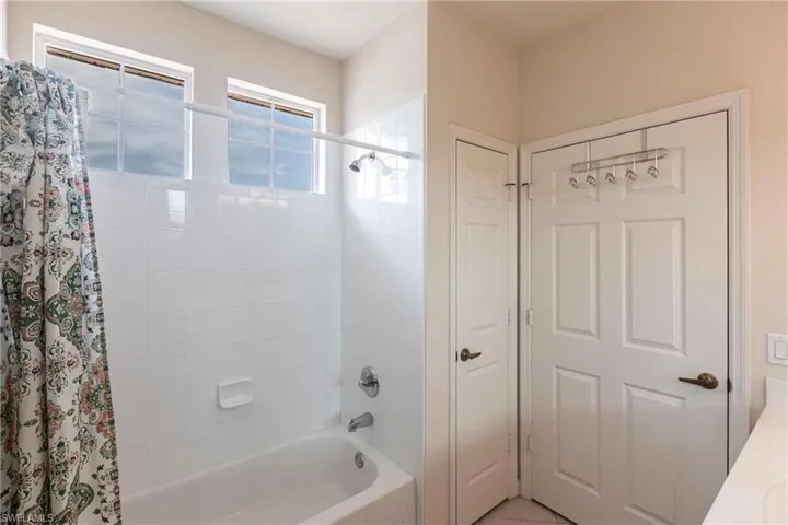 Bathroom featuring shower / tub combo and tile patterned floors