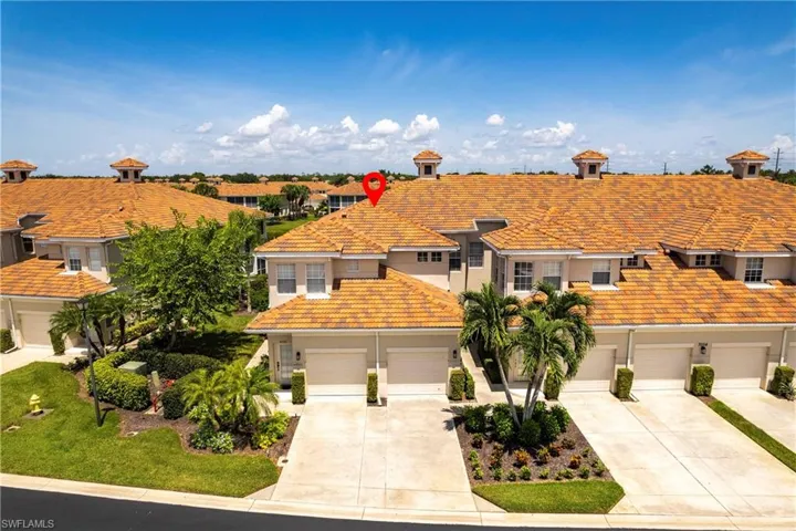 View of front of property with a tiled roof, stucco siding, driveway, and a garage