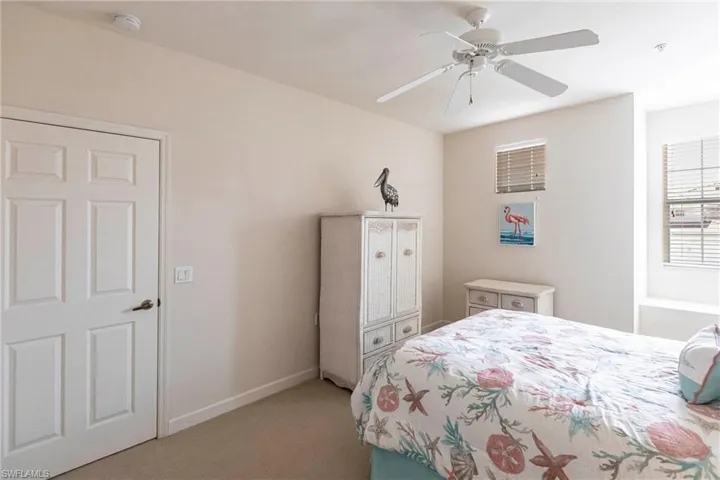 Bedroom featuring light colored carpet and a ceiling fan