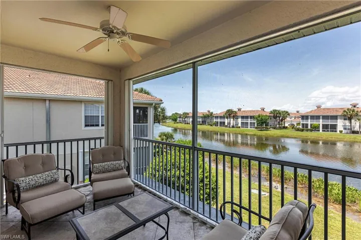 Sunroom / solarium featuring a water view