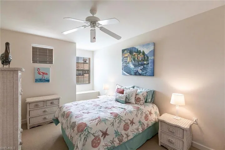 Bedroom with a ceiling fan and carpet floors