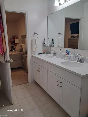 Master bathroom with tile patterned flooring and vanity